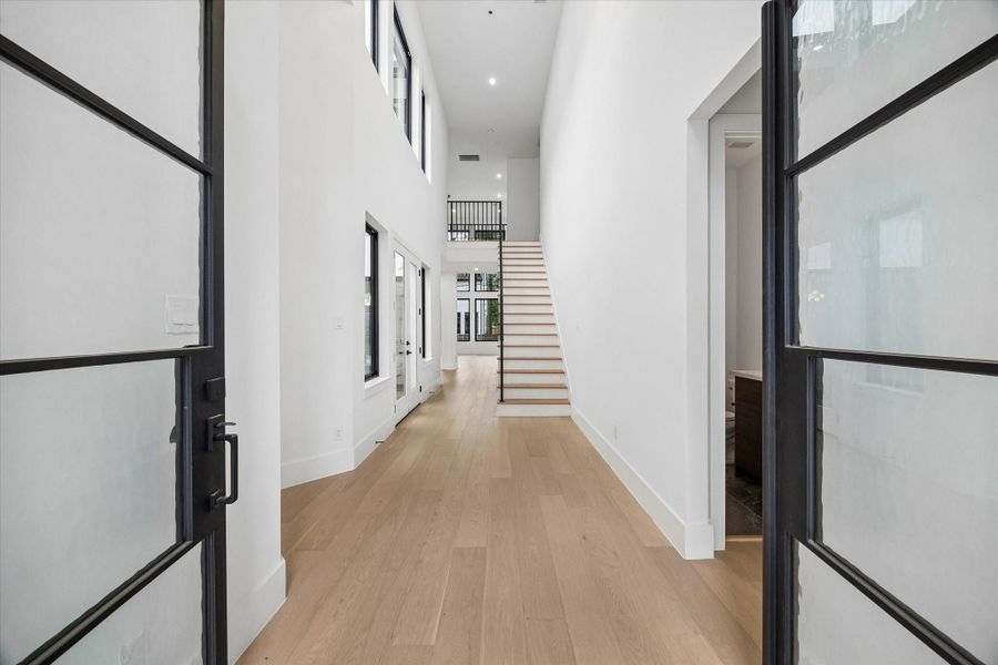 Natural light from double story windows to the open central courtyard lead the way. The eye is carried right through the back to the full depth of the 125 foot lot.
