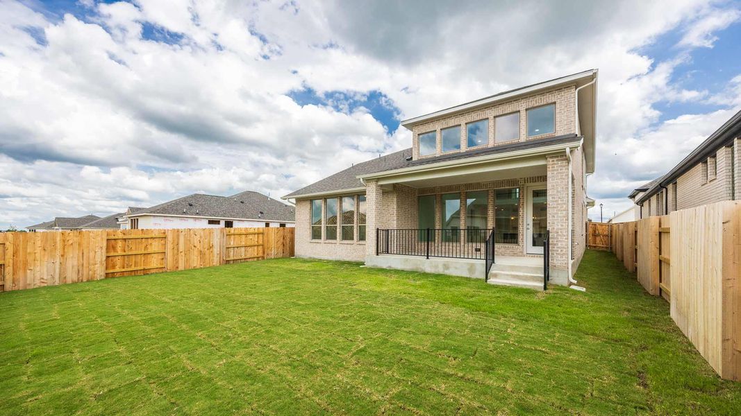 Rear view of property featuring brick siding Rear view of property featuring brick siding