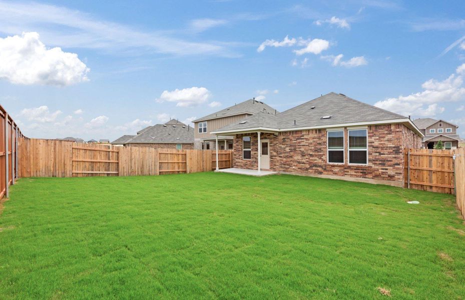 Front exterior of a new home in Sunfield, Buda, TX, highlighting curb appeal (Image 1). Front exterior of a new home in Sunfield, Buda, TX, highlighting curb appeal (Image 1).