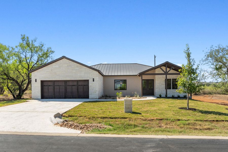 Front exterior of a new home in , Horseshoe Bay, TX, highlighting curb appeal (Image 27). Front exterior of a new home in , Horseshoe Bay, TX, highlighting curb appeal (Image 27).