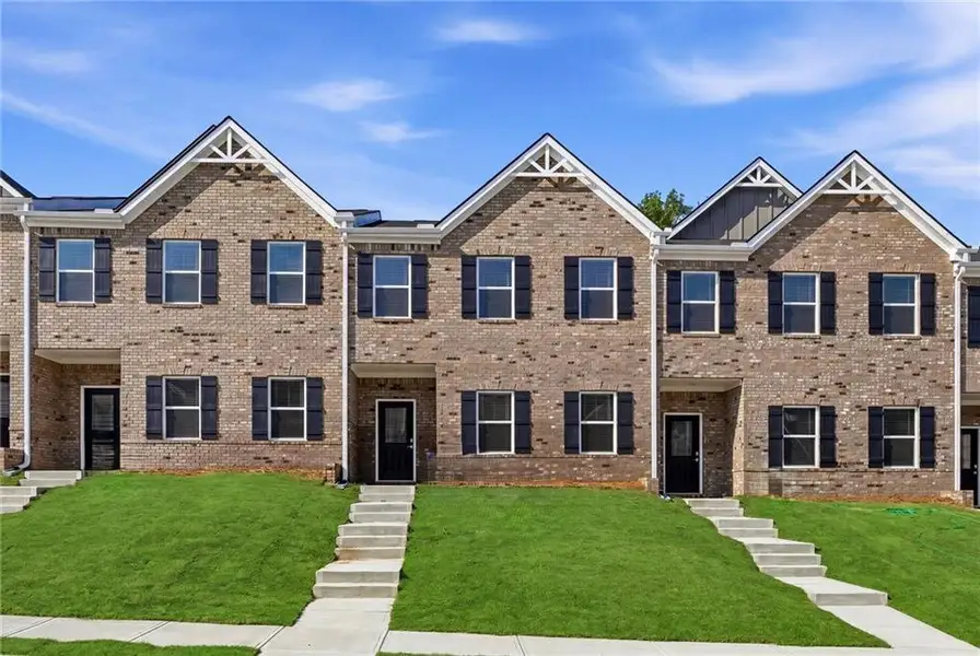 Front exterior of a new home in Parkway James, Snellville, GA, highlighting curb appeal (Image 1). Front exterior of a new home in Parkway James, Snellville, GA, highlighting curb appeal (Image 1).