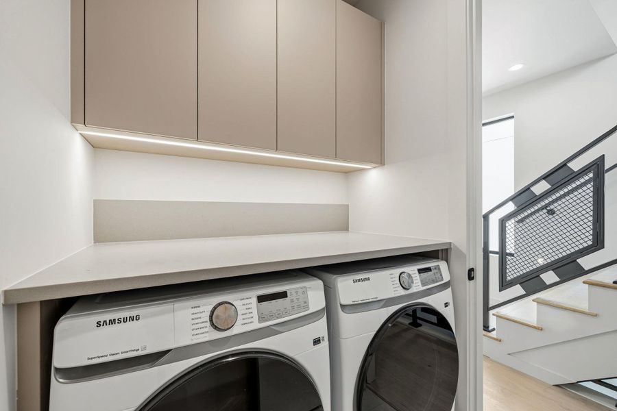 A dedicated laundry room provides utility and convenience with under-cabinet lighting. A dedicated laundry room provides utility and convenience with under-cabinet lighting.