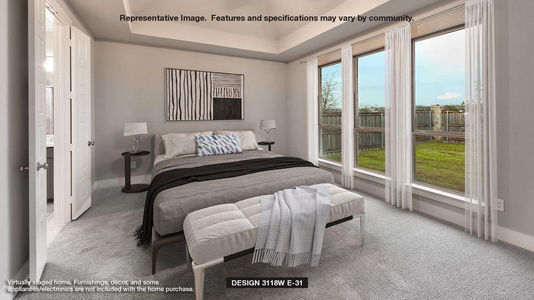 Carpeted bedroom featuring a raised ceiling and baseboards