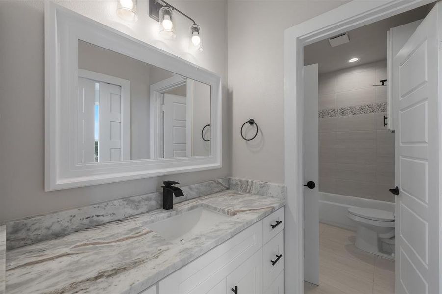 Full bath with vanity, toilet, tub / shower combination, and tile patterned floors