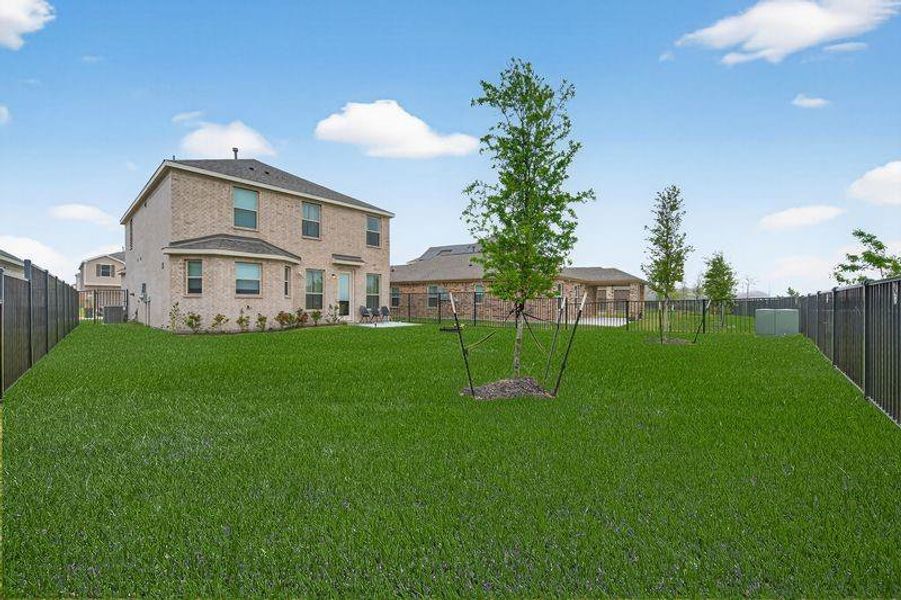 Premium lot with no rear neighbors, extended concrete patio, and fully fenced, wide-open backyard.