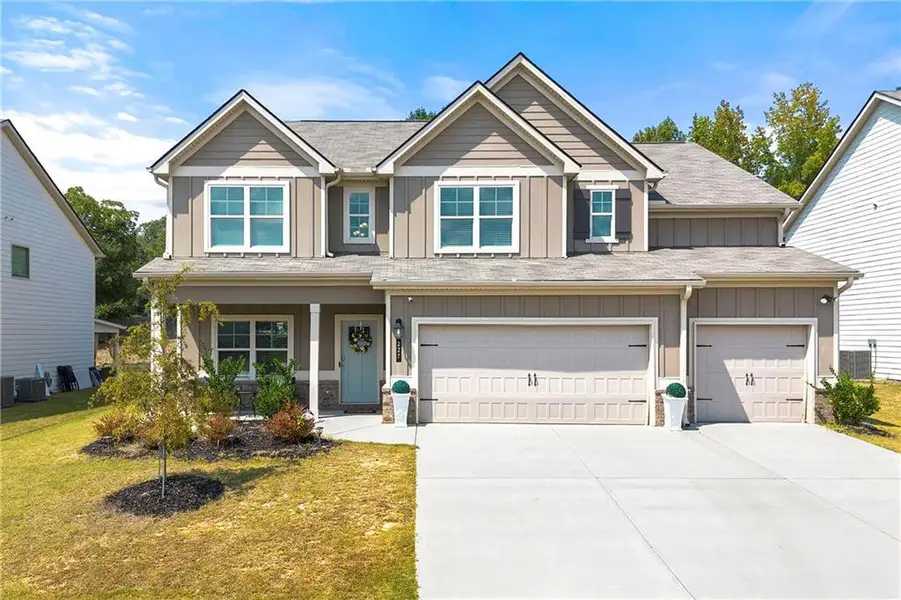 Front exterior of a new home in , Loganville, GA, highlighting curb appeal (Image 21).