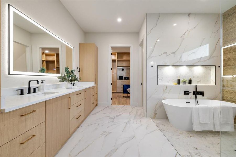 Bathroom with a tub, tile walls, and vanity