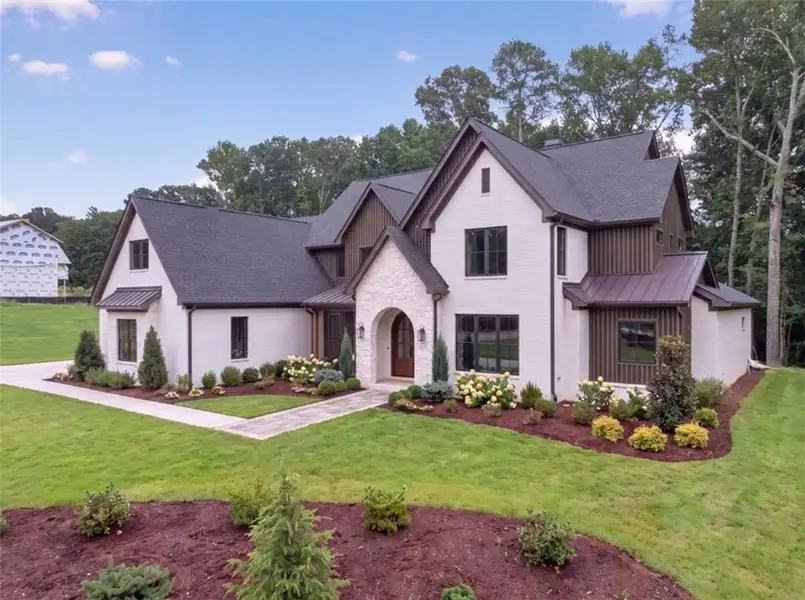 Front exterior of a new home in , Loganville, GA, highlighting curb appeal (Image 2). Front exterior of a new home in , Loganville, GA, highlighting curb appeal (Image 2).