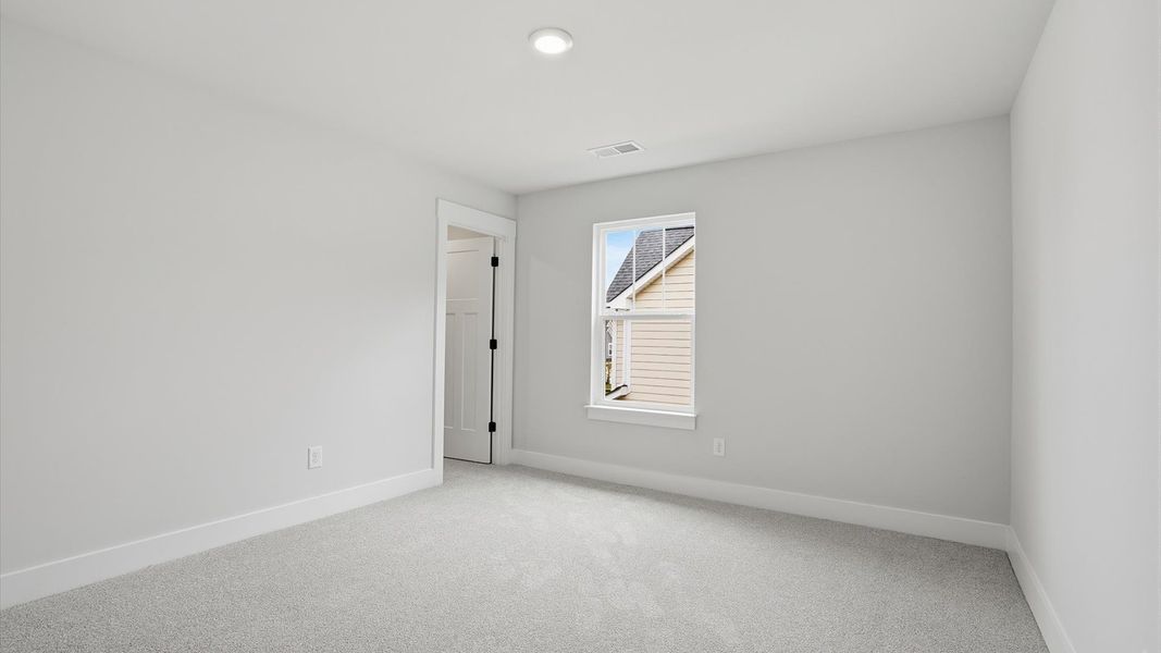 Refined bedroom design with a large window for daylight-filled mornings and peaceful views located at Creeks at Midway