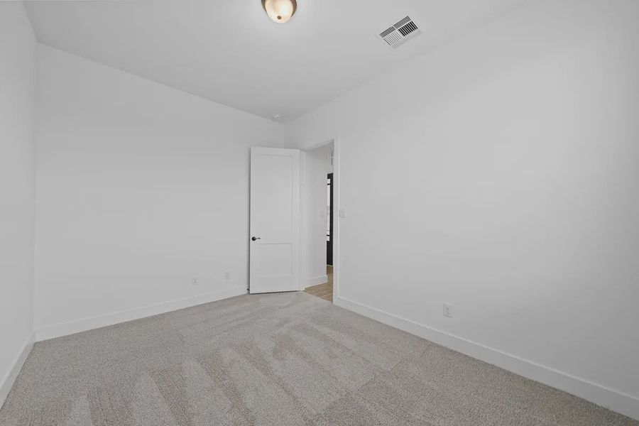 Representative unfurnished interior of a home built from the Summerton by Chesmar Homes in University Heights, Round Rock (Image 19).