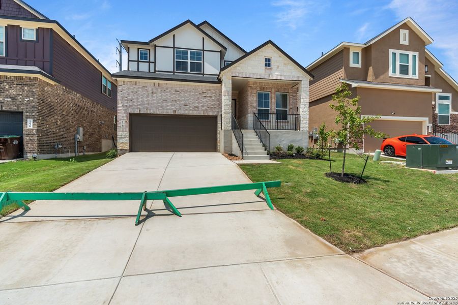 Front exterior of a new home in Hunters Ranch, San Antonio, TX, highlighting curb appeal (Image 27).