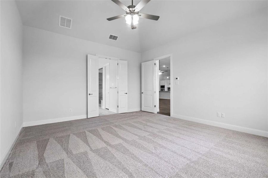 Unfurnished bedroom with carpet floors, baseboards, and visible vents