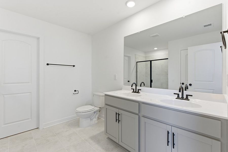 A bathroom with a large mirror.