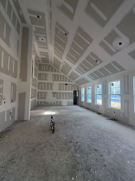 Living room features 18 ft ceiling and 6 large windows.