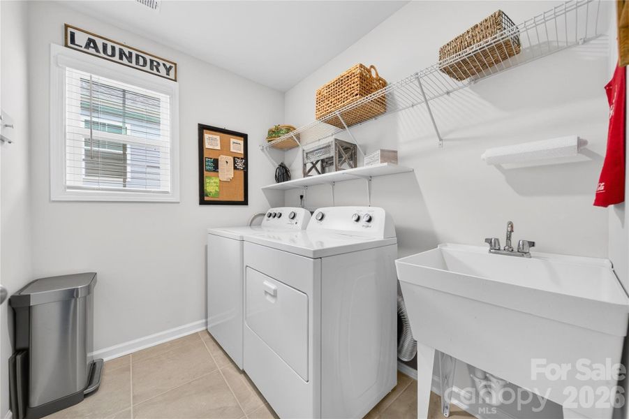 The laundry room is conveniently located on the second floor and includes a utility sink. The washer and dryer convey.
