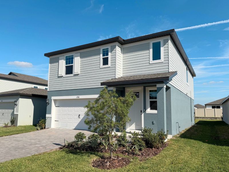 Front exterior of a new home in Two Rivers - Premier Series, Zephyrhills, FL, highlighting curb appeal (Image 2).