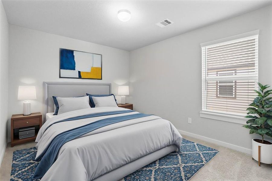 Secondary bedroom features plush carpet, neutral paint and a large window with privacy blinds.