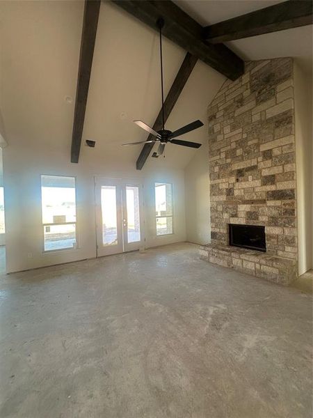 Large living with cathedral ceiling, stained beams and double back patio door Large living with cathedral ceiling, stained beams and double back patio door