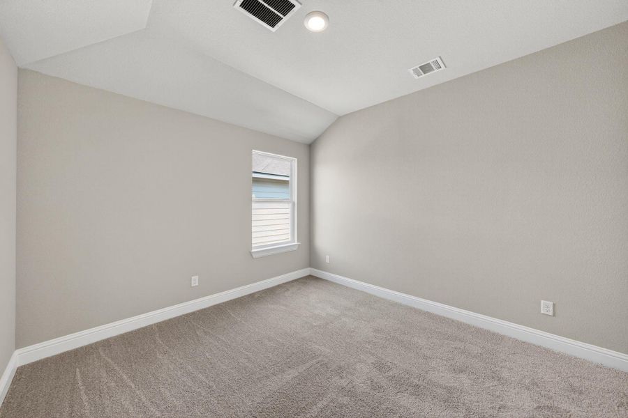 Carpeted empty room with lofted ceiling and recessed lighting Carpeted empty room with lofted ceiling and recessed lighting