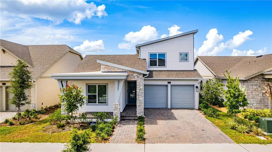 Front exterior of a new home in Laureate Park (Craft Homes), Orlando, FL, highlighting curb appeal (Image 2). Front exterior of a new home in Laureate Park (Craft Homes), Orlando, FL, highlighting curb appeal (Image 2).
