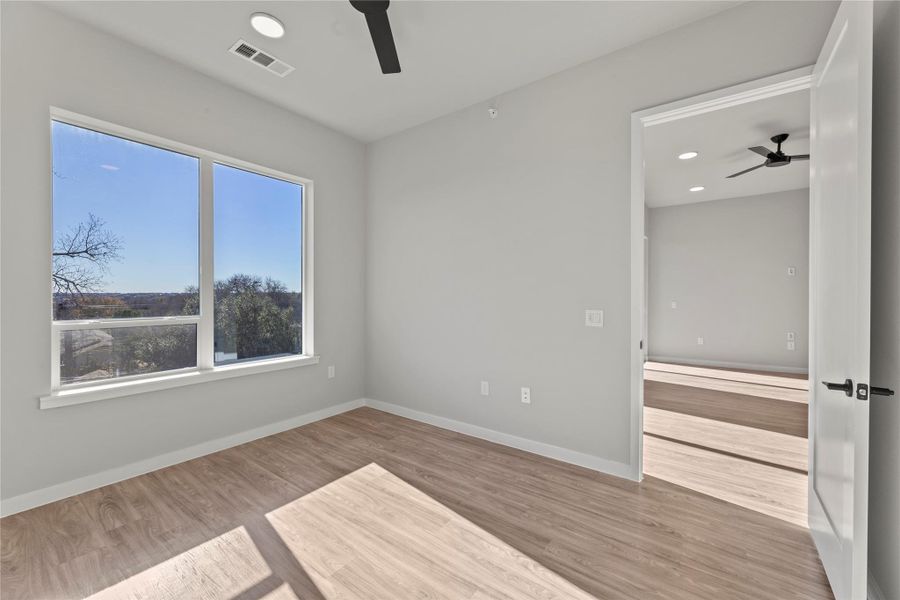 Empty room featuring wood-type flooring and ceiling fan