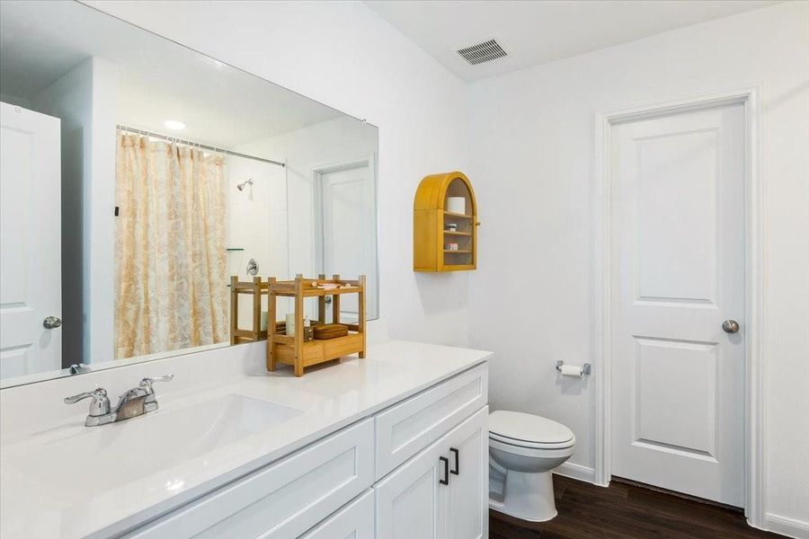 Primary bathroom features ample counter space and walk in shower. Primary bathroom features ample counter space and walk in shower.