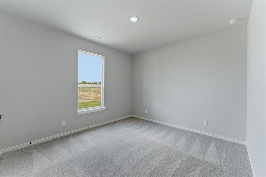 Unfurnished room with light colored carpet and baseboards