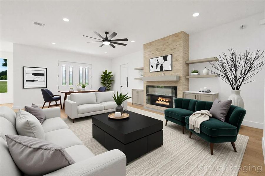 Living area with light wood-style floors, a large fireplace, a ceiling fan, and recessed lighting
