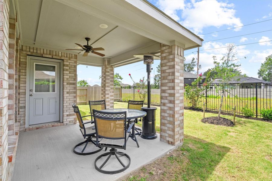 Texas evenings were made for this. The covered patio with a ceiling fan, brick columns, and a fenced backyard with green space just beyond the fence gives you the kind of outdoor living that makes staying home feel like a vacation. Texas evenings were made for this. The covered patio with a ceiling fan, brick columns, and a fenced backyard with green space just beyond the fence gives you the kind of outdoor living that makes staying home feel like a vacation.