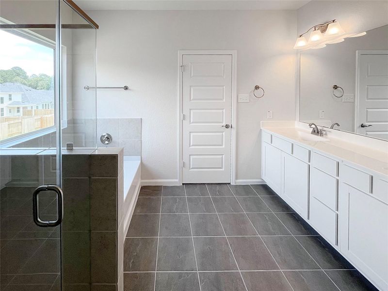The McGinnis- Primary Suite Dual Sinks, Garden Tub, and Walk-in Shower. The McGinnis- Primary Suite Dual Sinks, Garden Tub, and Walk-in Shower.