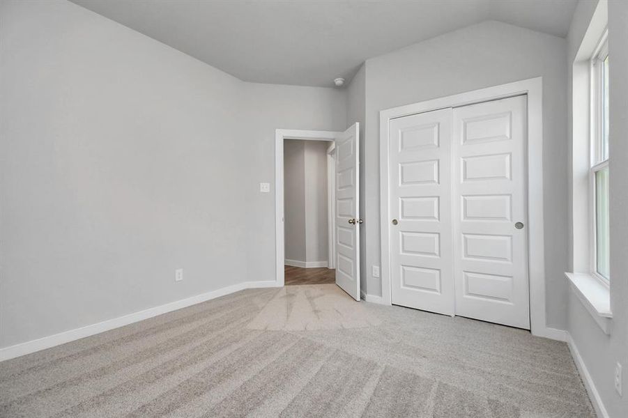 Generously sized secondary bedrooms featuring spacious closets, soft and inviting carpeting underfoot, large windows allowing plenty of natural light