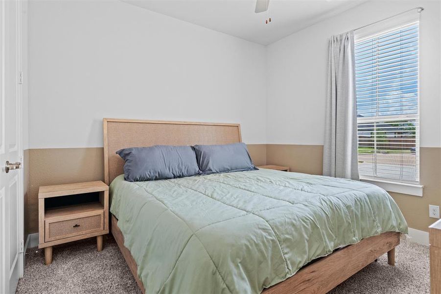 A secondary bedroom with a nice sized window looking to the front yard.