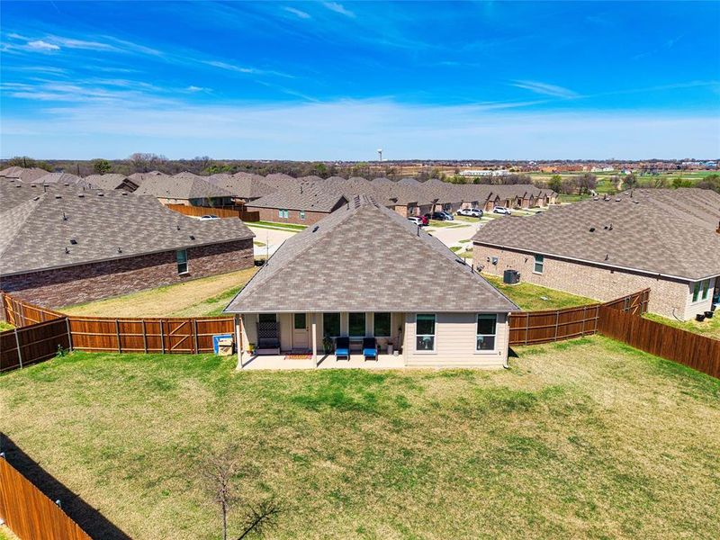 Rear view of property featuring a shingled roof, a patio, a residential view, and a fenced backyard Rear view of property featuring a shingled roof, a patio, a residential view, and a fenced backyard