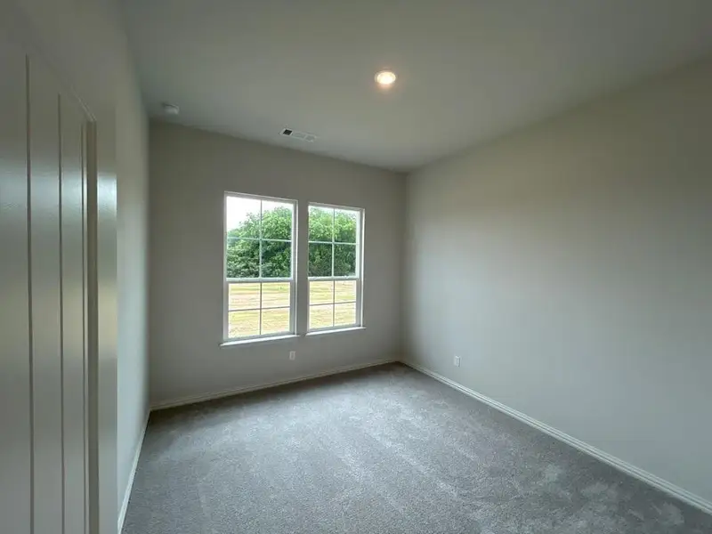 Room featuring two pane windows, light grey wall paint, plush grey carpeting, white baseboards, and a recessed ceiling light