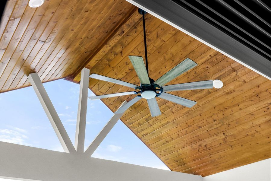 A striking wooden ceiling showcases a contemporary ceiling fan, adding both style and comfort.
