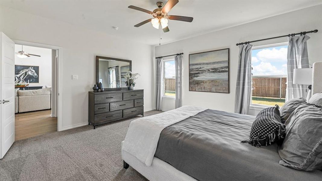 Spacious room featuring light-colored walls, carpeted flooring, and a ceiling fan with integrated lighting Spacious room featuring light-colored walls, carpeted flooring, and a ceiling fan with integrated lighting