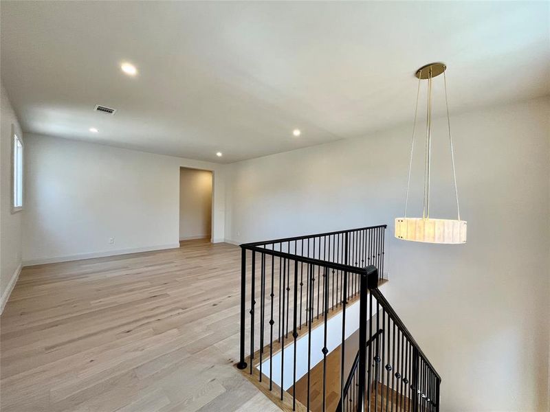 Hallway with light hardwood / wood-style floors