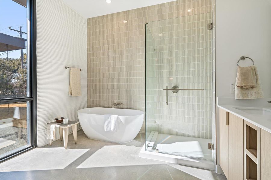 Bathroom with tile walls, vanity, and independent shower and bath