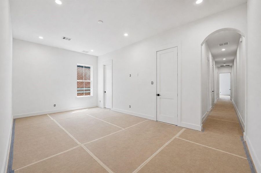 Beautiful arched doorway in game room/flex space leads to the second floor bedrooms Beautiful arched doorway in game room/flex space leads to the second floor bedrooms