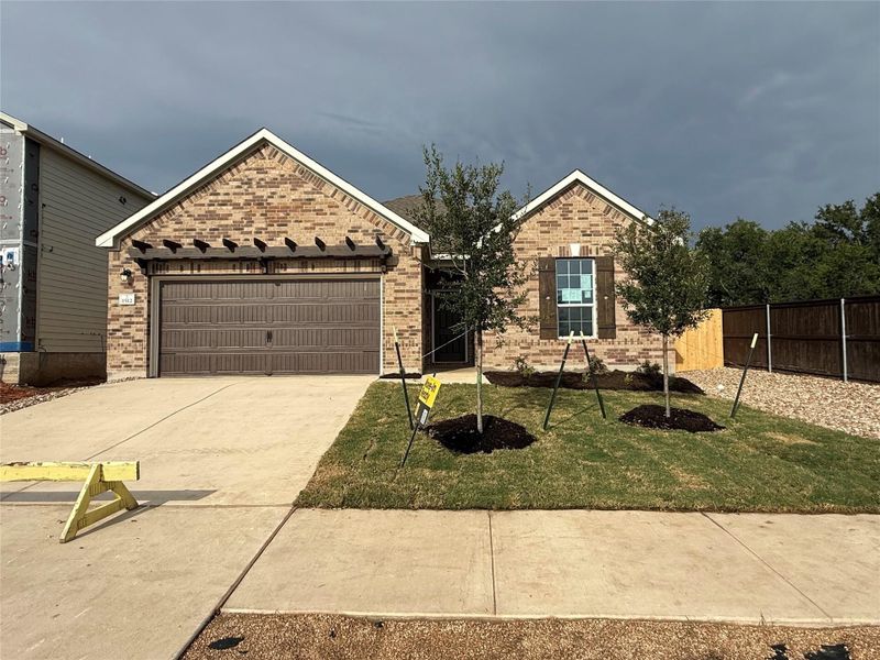Front exterior of a new home in River Bluff, Leander, TX, highlighting curb appeal (Image 1).