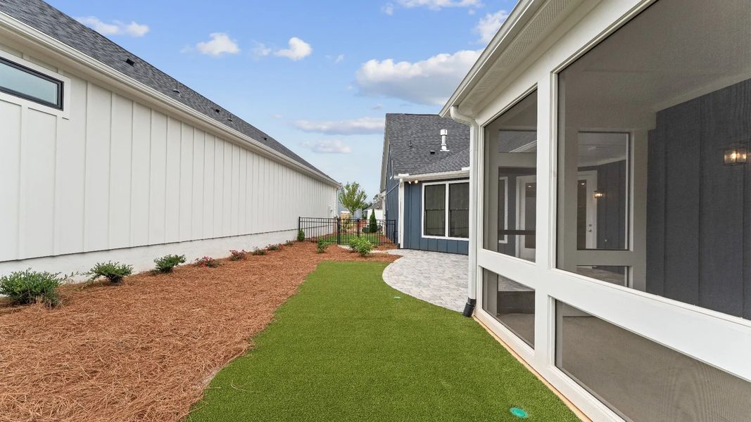 Exterior details and patio area of a home in The Courtyards at Redbud Lane, Canton (Image 18).