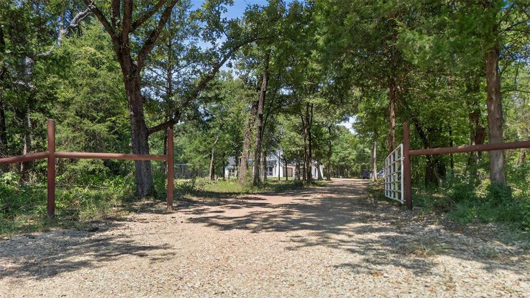 View of dirt / gravel driveway with a gated entry View of dirt / gravel driveway with a gated entry