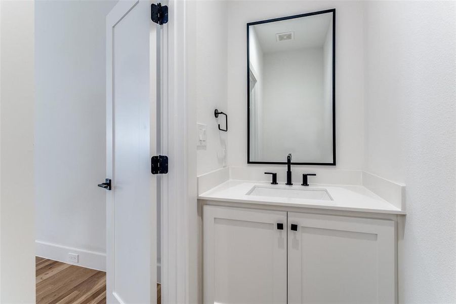 Bathroom featuring vanity and wood finished floors Bathroom featuring vanity and wood finished floors