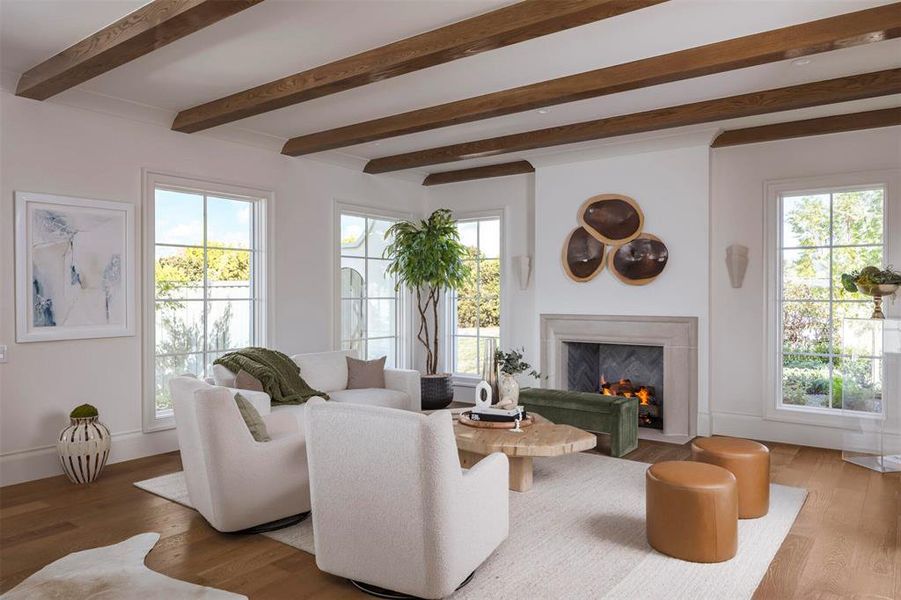 Living room featuring beam ceiling, wood finished floors, plenty of natural light, and a premium fireplace Living room featuring beam ceiling, wood finished floors, plenty of natural light, and a premium fireplace