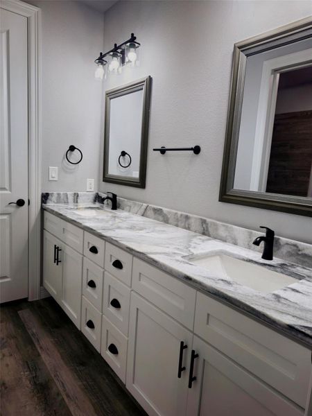 Hollywood-style bathroom with a dual-sink vanity, ample storage.