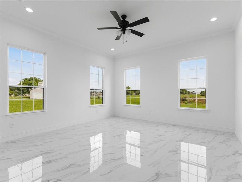 Spare room with ornamental molding, baseboards, recessed lighting, marble finish floors, and ceiling fan
