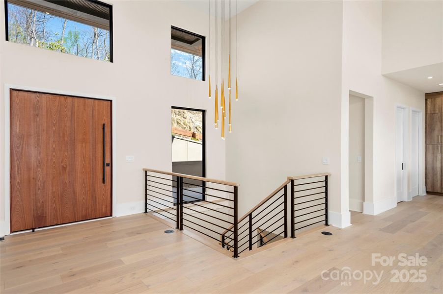 The grand entry and stunning dramatic staircase lighting