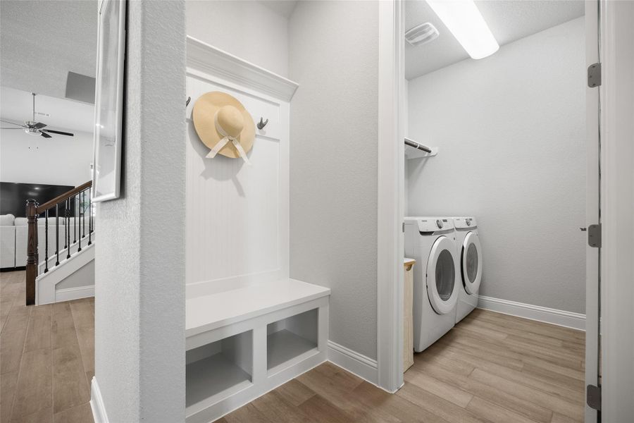 A thoughtfully designed mudroom is conveniently located just off the garage and front entry, offering a seamless transition into the laundry room—perfect for keeping everyday essentials organized and out of sight.