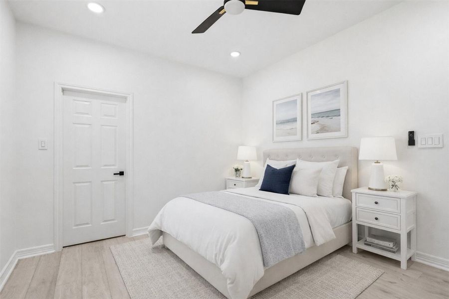 Second floor bedroom with ceiling fan, natural light, and room for a full size bed.