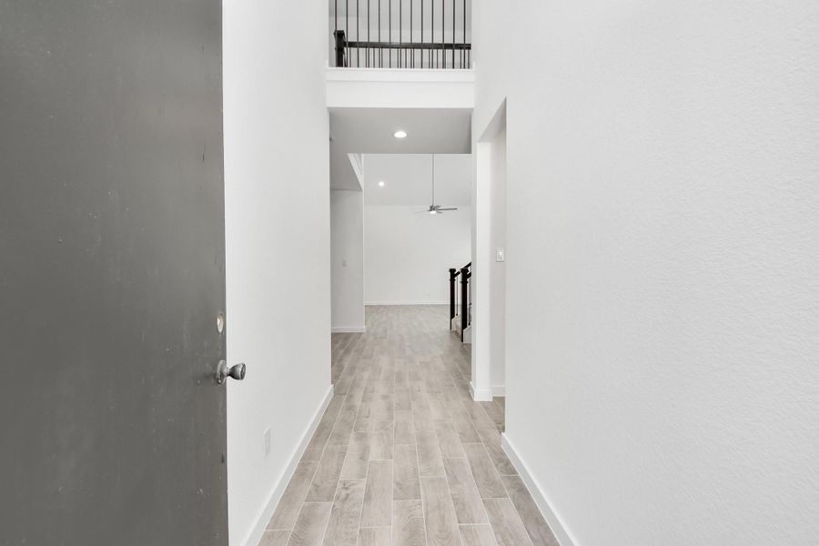 As you step into the threshold of this luxurious home, you'll soon be welcomed by an elegant glass door (to be installed). Inside, soaring ceilings amplify the spaciousness, while the refined wood-look tile flooring and oversized baseboards exude sophistication and charm. Sample photo of completed home with similar floor plan. Actual colors and selections may vary. As you step into the threshold of this luxurious home, you'll soon be welcomed by an elegant glass door (to be installed). Inside, soaring ceilings amplify the spaciousness, while the refined wood-look tile flooring and oversized baseboards exude sophistication and charm. Sample photo of completed home with similar floor plan. Actual colors and selections may vary.